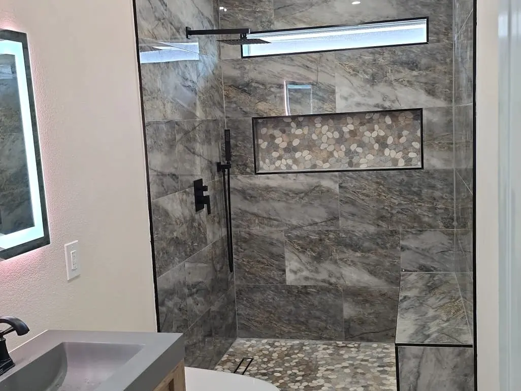 Finished — stone tile, glass shower and fitted vanity