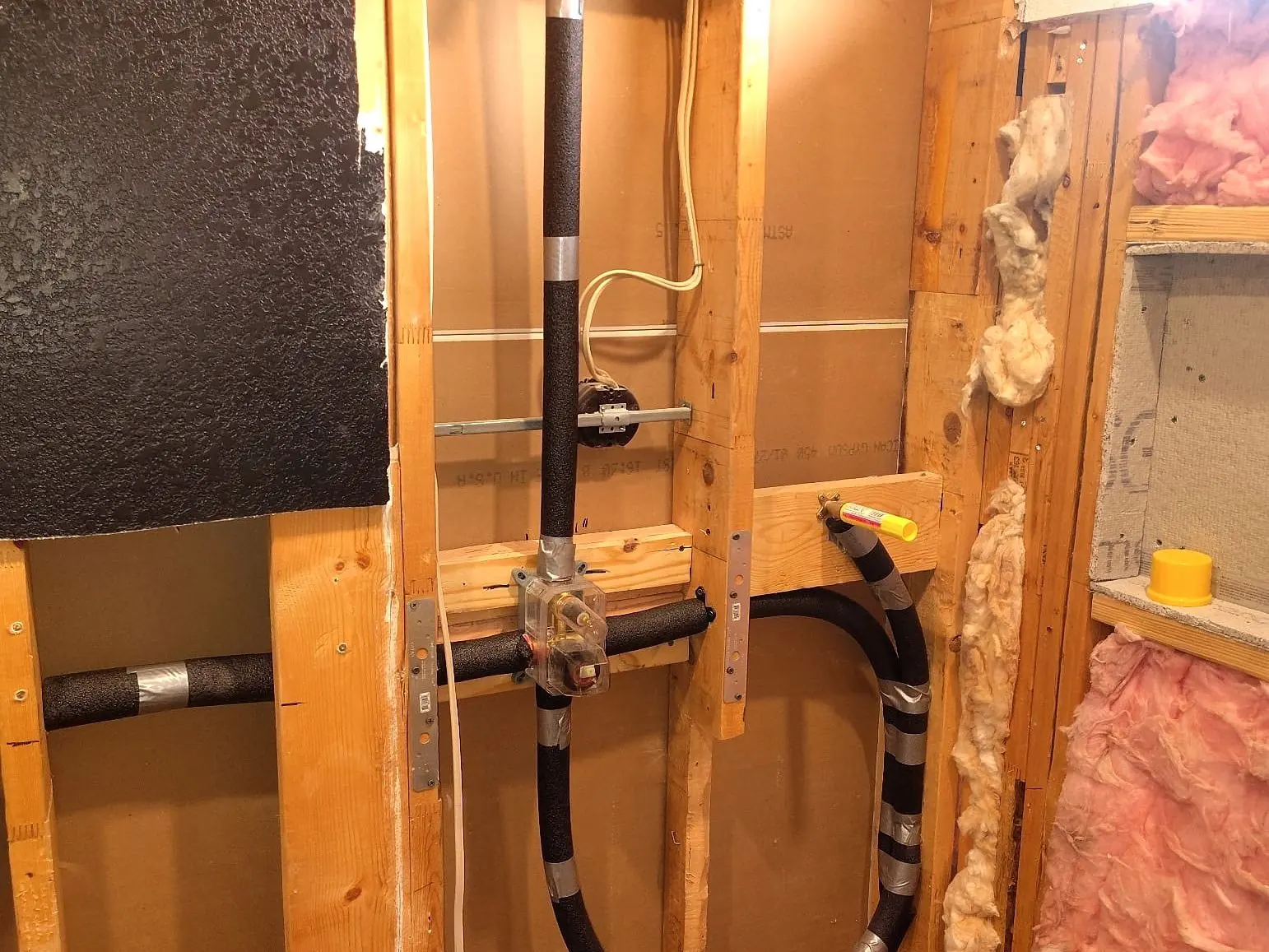 Rough-in — shower plumbing set between new studs