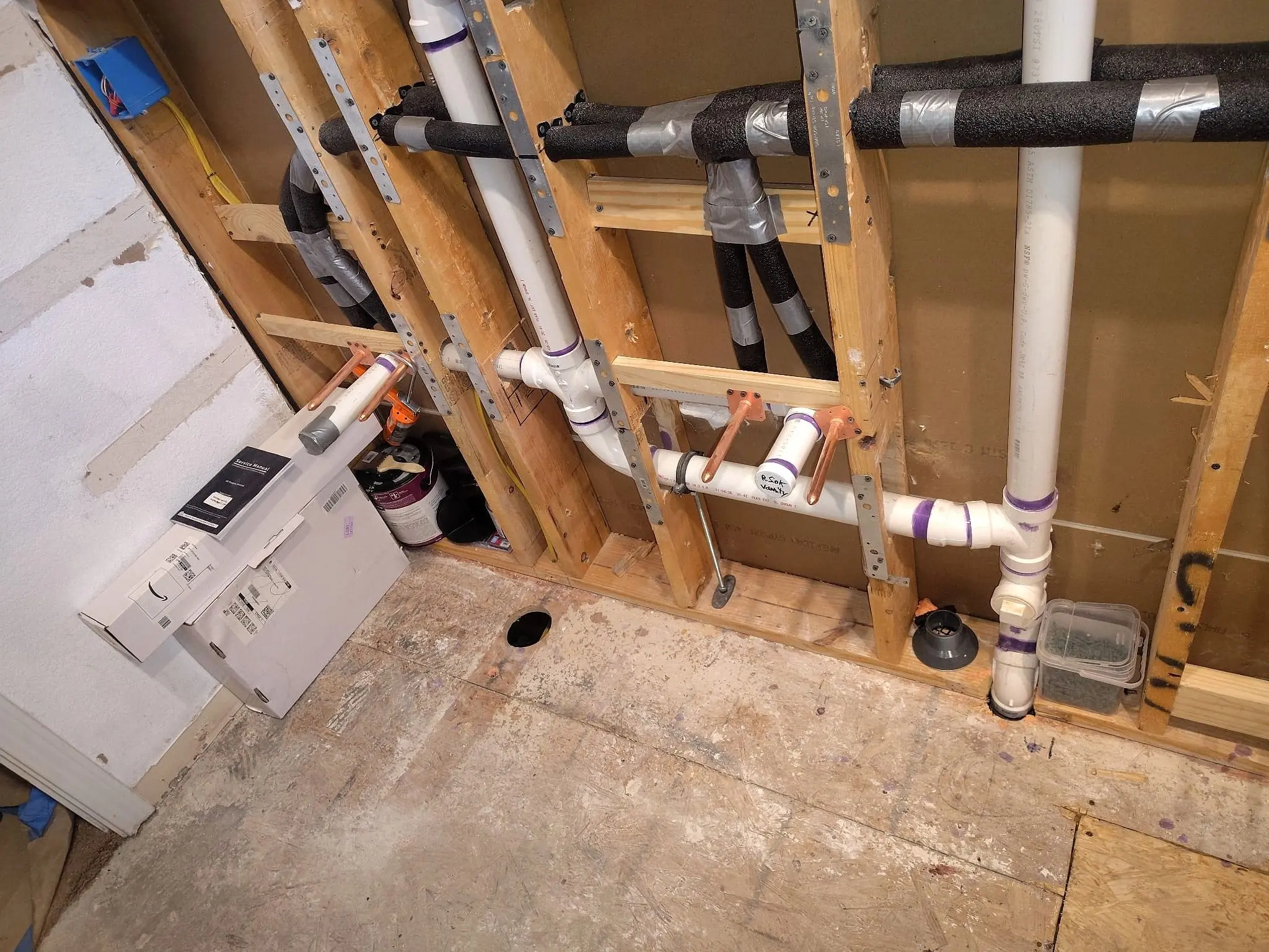 Rough-in — drains and supply run in an opened floor