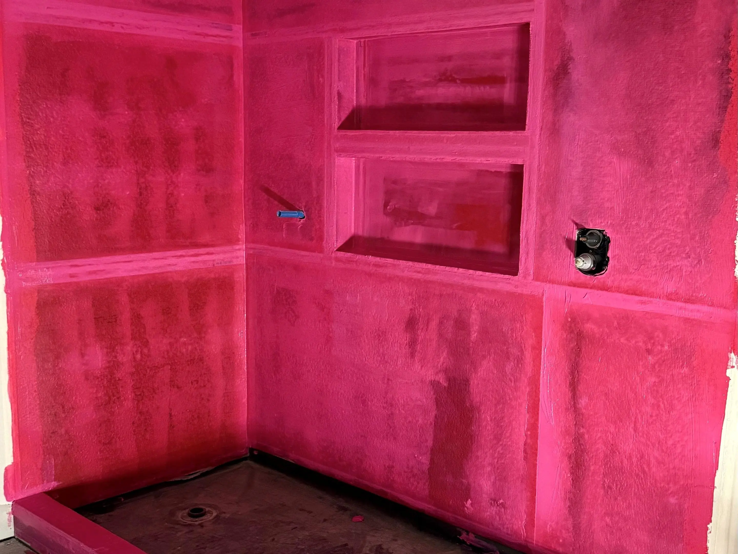 Waterproofing — pan and niches sealed before any tile